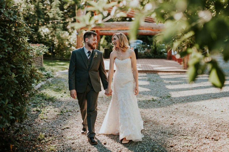 Modern bride and groom at Black Diamond Gardens, with groom in a grey suit and vest, and bride in a strapless dress. 