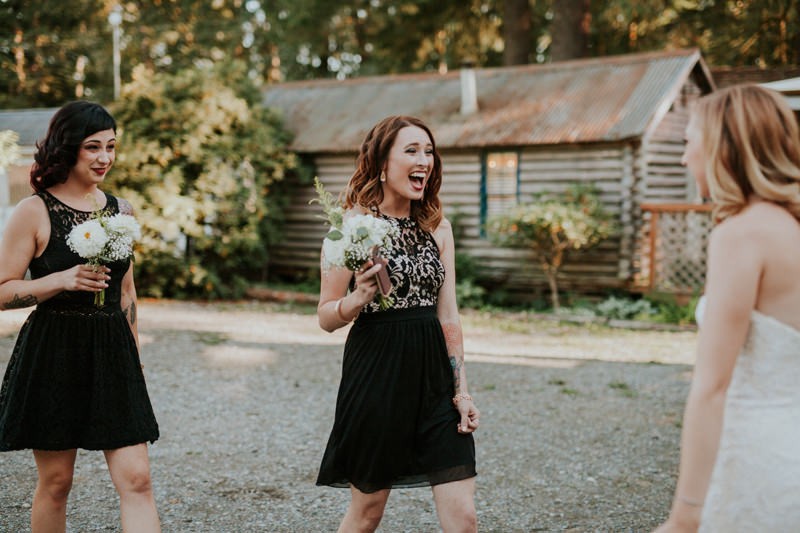 Garden glam bridesmaids wearing short black dresses, at Black Diamond Gardens.