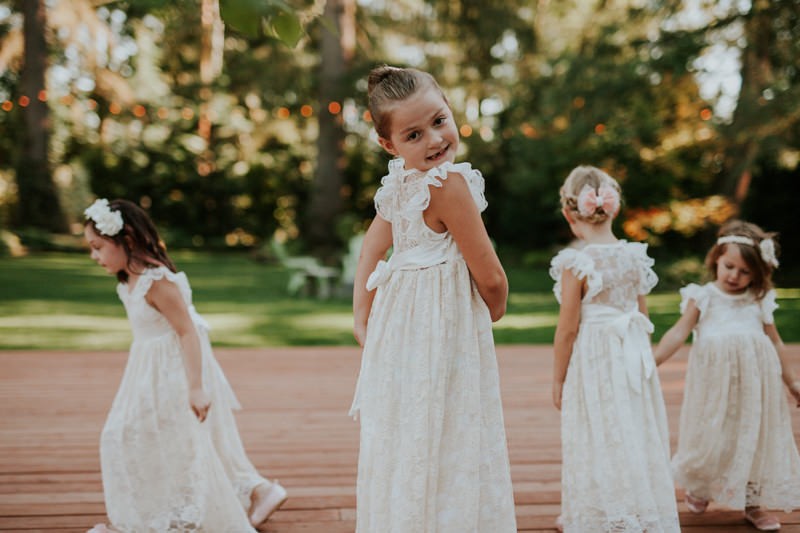 Garden wedding flower girls dancing, at Black Diamond Gardens, in dreamy vintage-inspired lace dresses. 