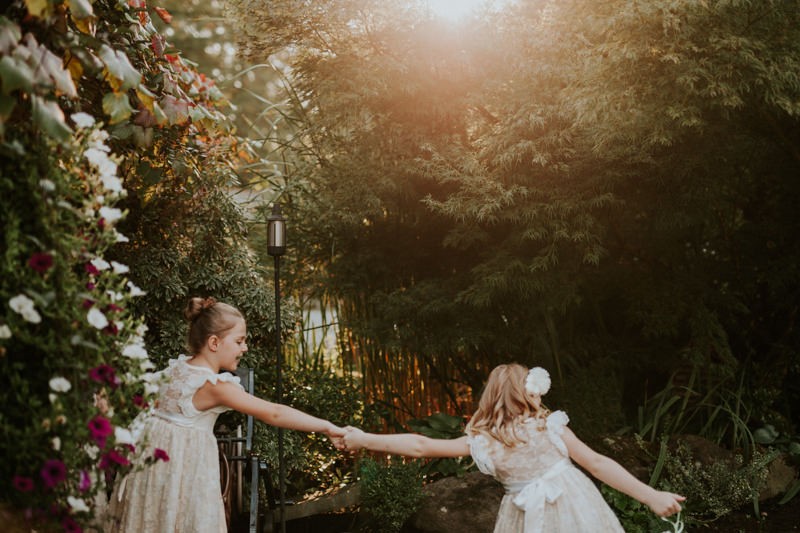 Flower girls playing as the sun sets, at Black Diamond Gardens. 