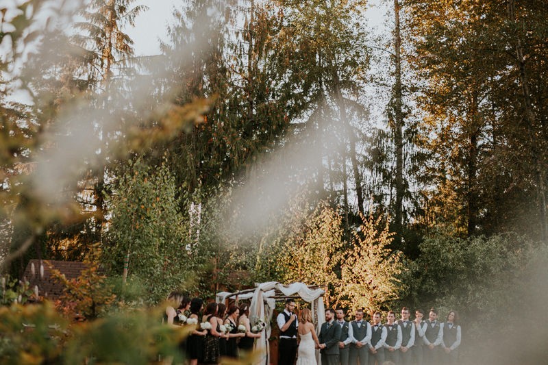 Outdoor garden wedding with large wedding party. 