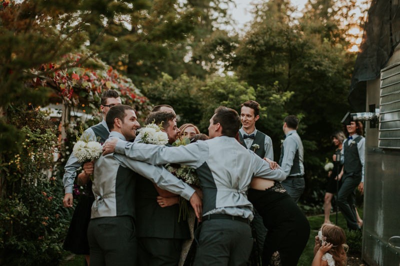 Wedding party group hug, celebrating the ceremony, in Black Diamond, WA. 