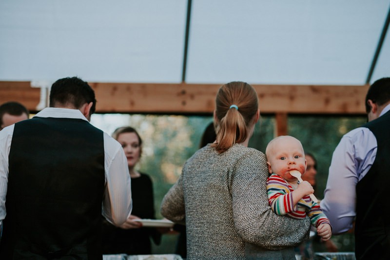 Baby wedding guest with food on their cheeks, in Black Diamond, WA. 