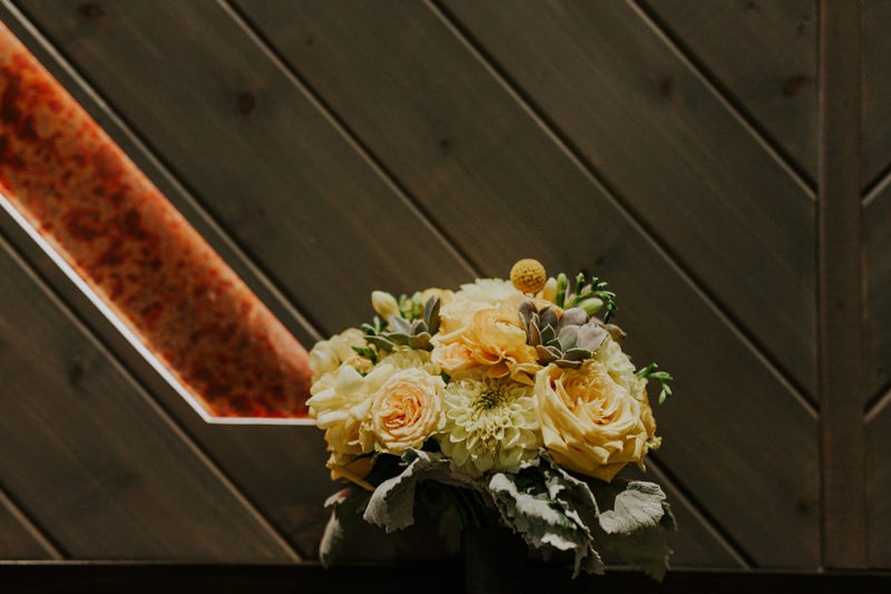 Modern yellow floral bouquet, with Roses, Dahlias, Succulents, and Billy Balls. 