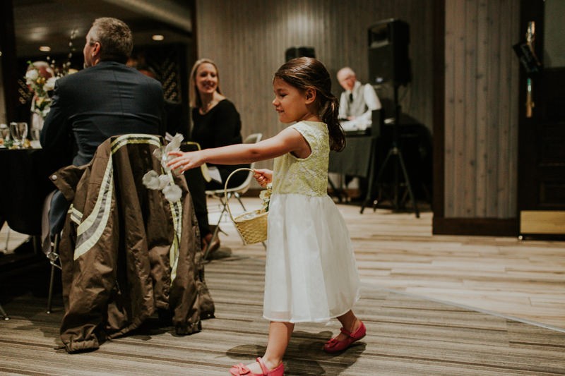 Flower girl sprinkles petals during the wedding processional. 