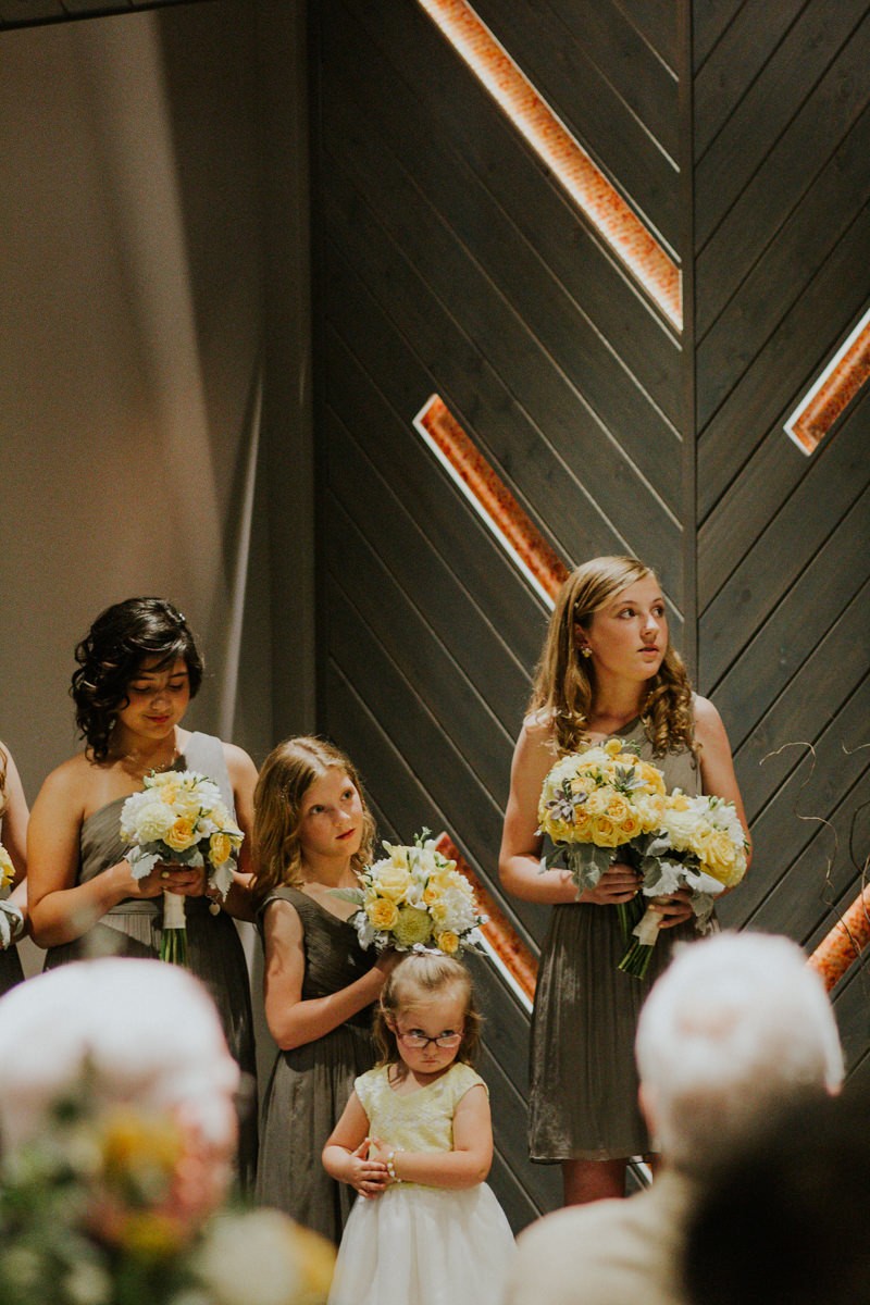 Junior bridesmaids and flower girls watch intently as the bride and groom exchange vows. 