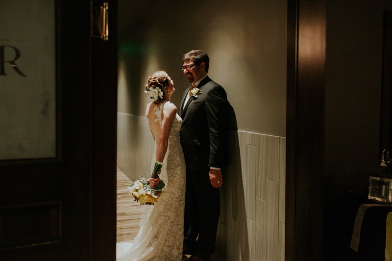 Bride and groom smiling and cuddling after their ceremony. 