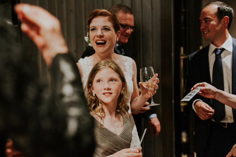 Bride smiling and mingling with guests, during a modern reception at The Pine Room in Tacoma, WA. 