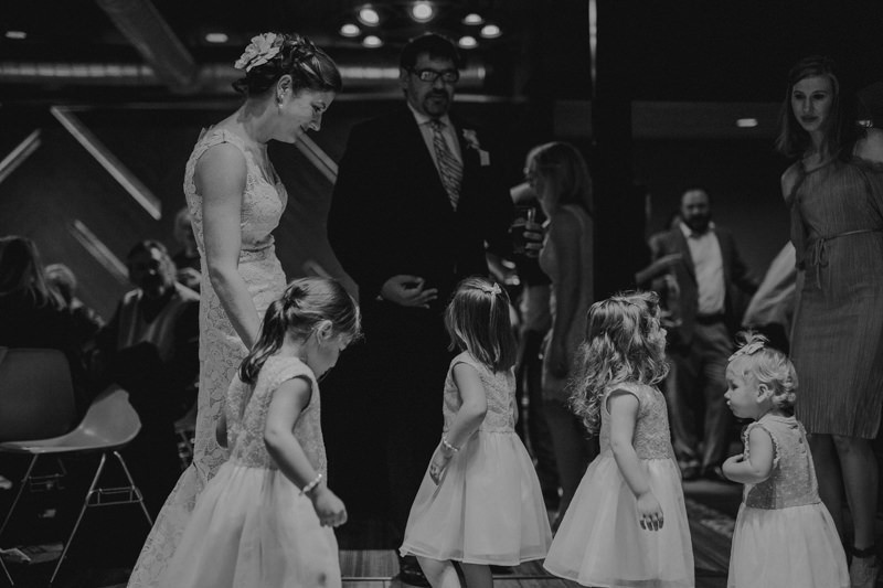 Bride and groom dancing with flower girls. 