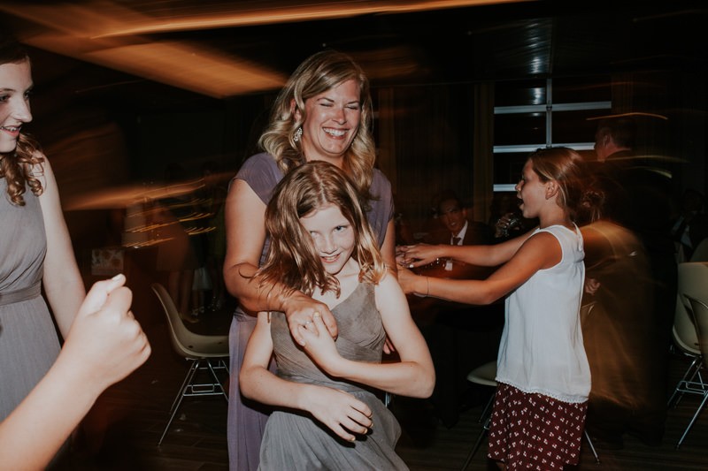 Junior bridesmaids dancing during a modern wedding reception. 