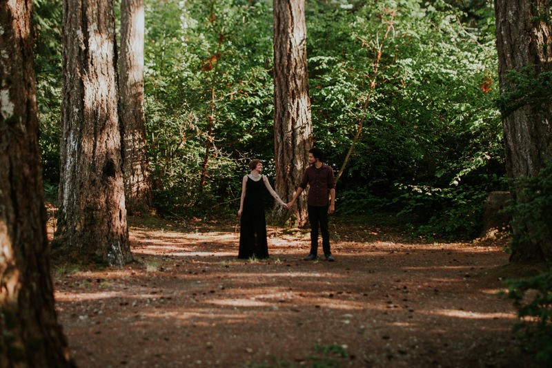 Modern couple in the woods, holding hands, at Twanoh State Park. 