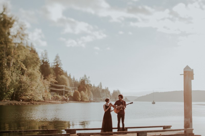 Sweet musician couple standing on a dock in Union, WA at sunset. 