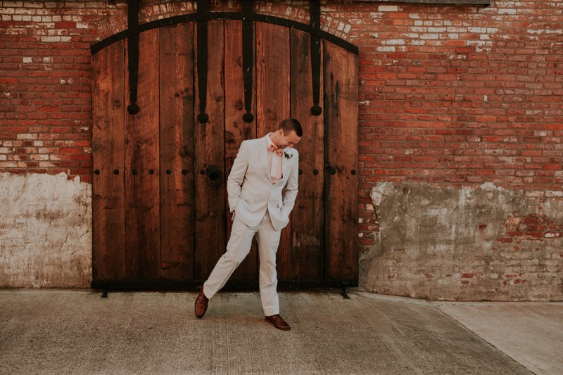 Groom wearing blue seersucker suit and coral bow tie for a Port Townsend winter elopement. 