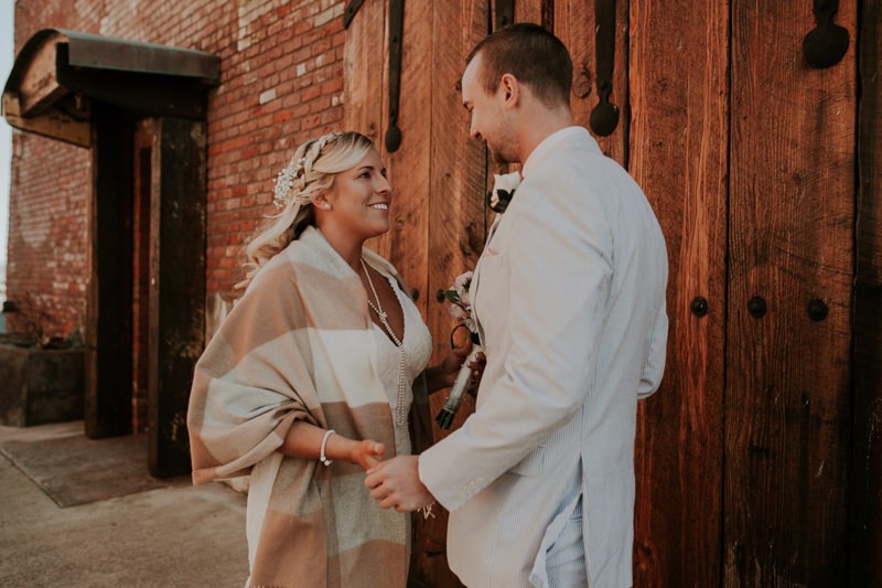 Port Townsend elopement, with bride in a lace v-neck dress and a braided half up-do. 