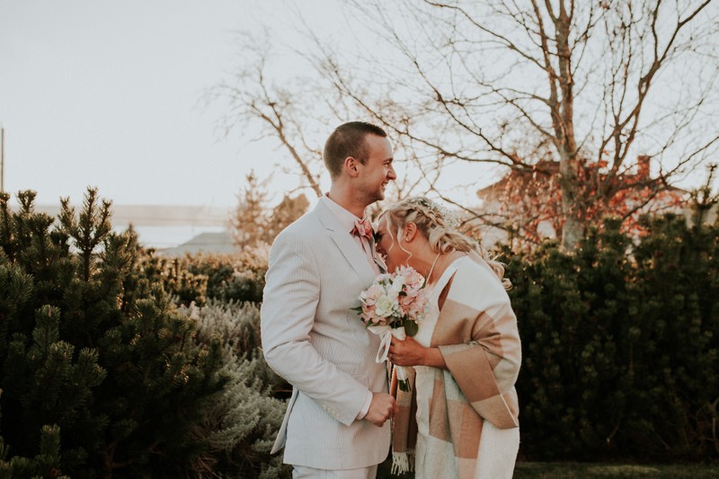 Romantic elopement, with groom in a blue seersucker suit and coral bow tie. 