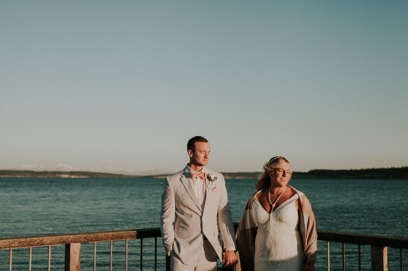 Bride and groom in a silent moment at sunset, on the Port Townsend waterfront. 