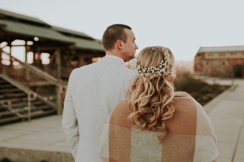 Winter elopement bride with a sweet braided half up-do, with Baby's Breath. 