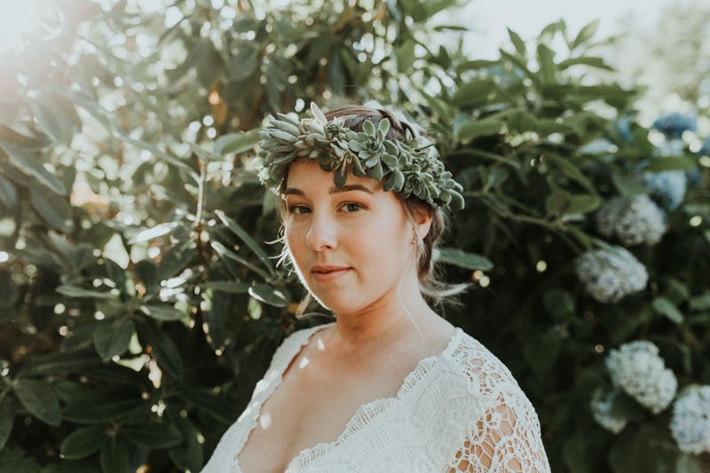 Goddess-vibes summer elopement style with bride wearing a succulent crown.