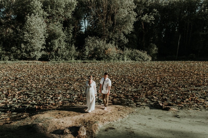 Modern bride and groom near a pond with lily pads in Hillsboro, Oregon. 