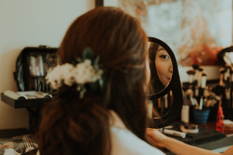 Bride getting ready in Bellevue, with fresh flowers in her hair. 