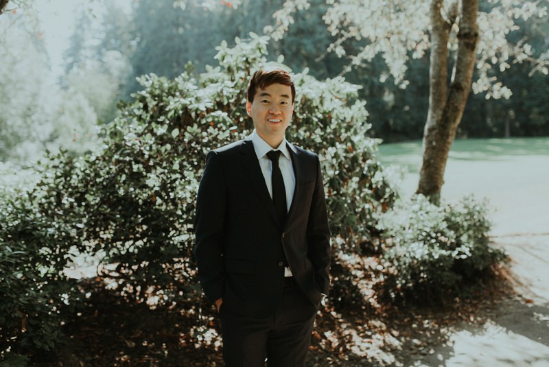Groom at Robinswood Park, wearing a blue suit with a black skinny tie. 