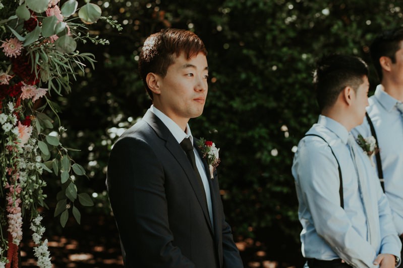 Modern groom in a dark blue suit with a skinny tie, for a Seattle summer wedding. 