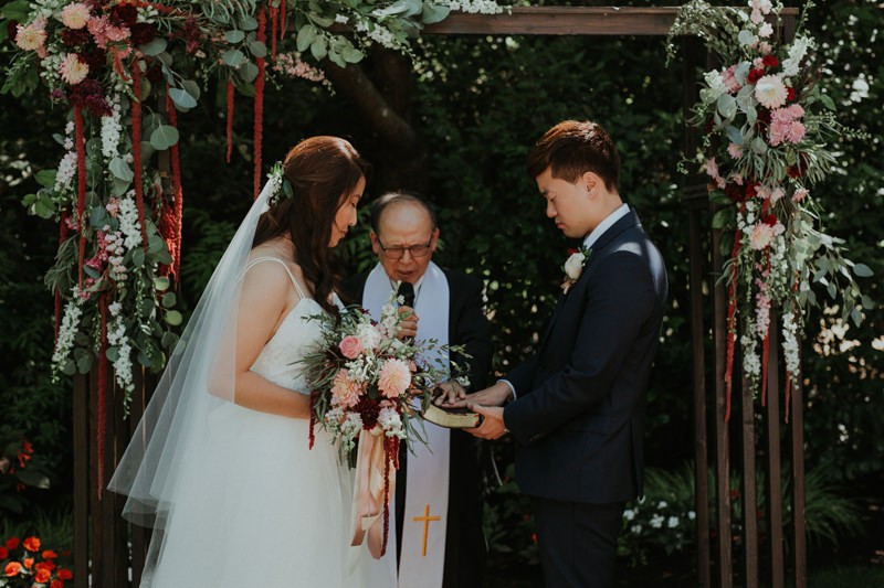 Sweet ceremony in a garden, at Seattle wedding venue Robinswood House. 