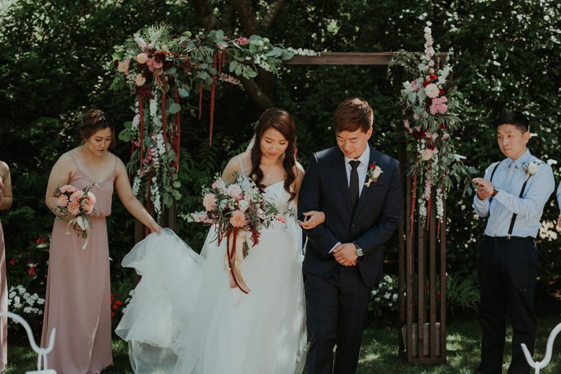 Wedding inspiration from garden ceremony with soft pink and burgundy florals. 