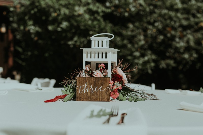 Garden wedding centerpiece with calligraphy and wooden table numbers