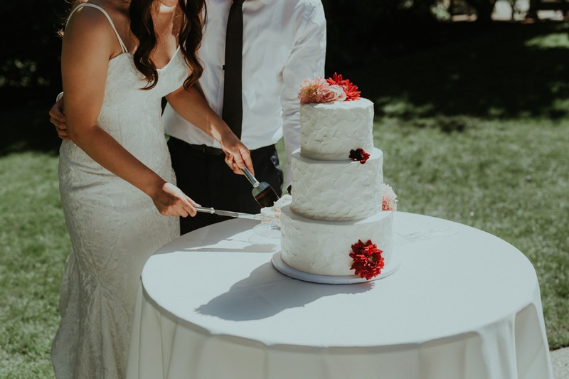 Bride and groom cut their classic buttercream cake.