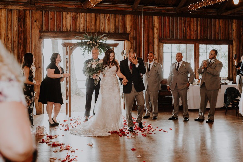 Indoor wedding ceremony with floral arch at Kitsap Memorial State Park | PNW wedding + elopement photographer Meghann Prouse | www.photomegs.com