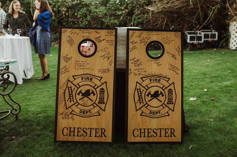 Custom-made firefighter cornhole wedding guest book at The Edgewater House with guest signatures | PNW wedding + elopement photographer Meghann Prouse | www.photomegs.com