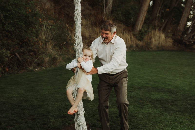 Kids having fun on a rope swing at The Edgewater House wedding | PNW wedding + elopement photographer Meghann Prouse | www.photomegs.com