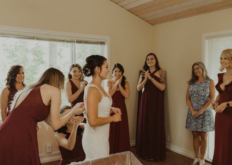 Bridesmaids helping bride button dress | Northwest Trek wedding day | Seattle wedding photographer
