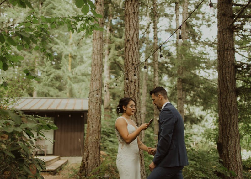 Bride reading personal vows to groom during first look | Northwest Trek wedding day | Seattle wedding photographer
