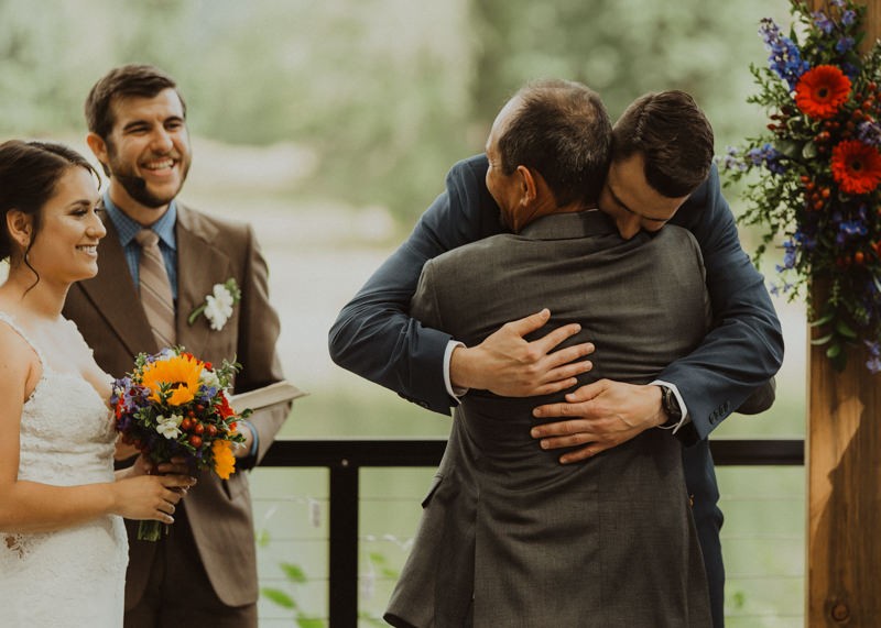 Groom hugging the bride's dad at the ceremony | Northwest Trek wedding day | Seattle wedding photographer
