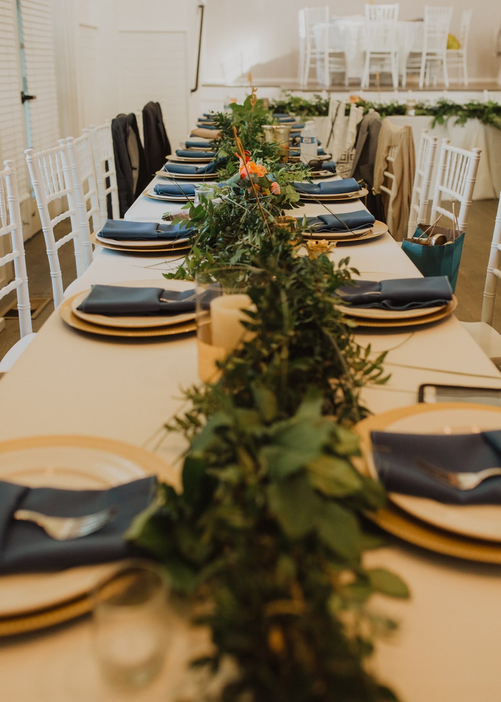 Greenery garlands on long tables for destination wedding reception. 