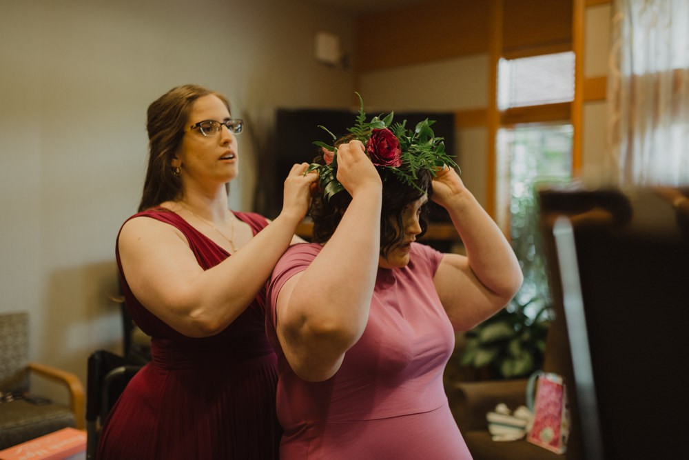Bride fitting flower crown during getting ready. 