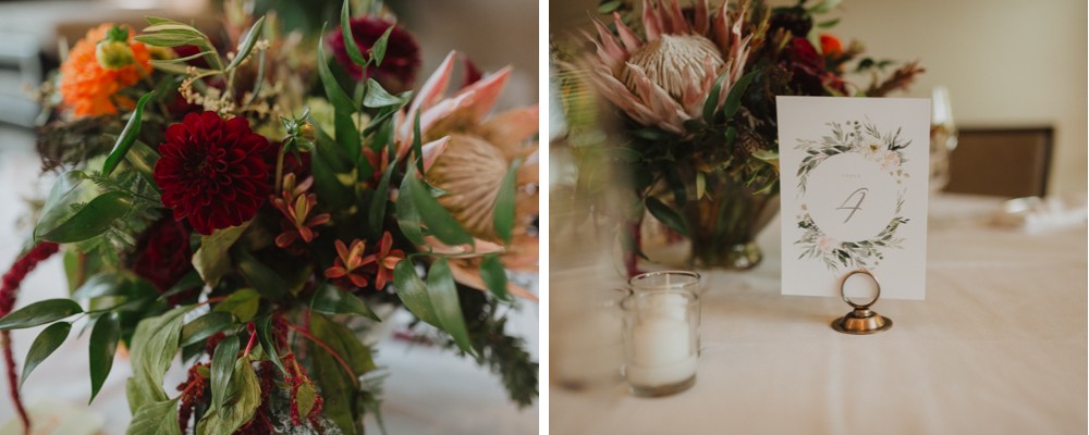 Boho wedding table signs and jewel tone floral centerpieces. 