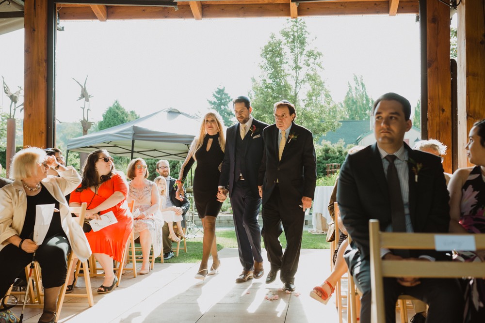 Groom walking down the aisle with his parents in Woodinville. 