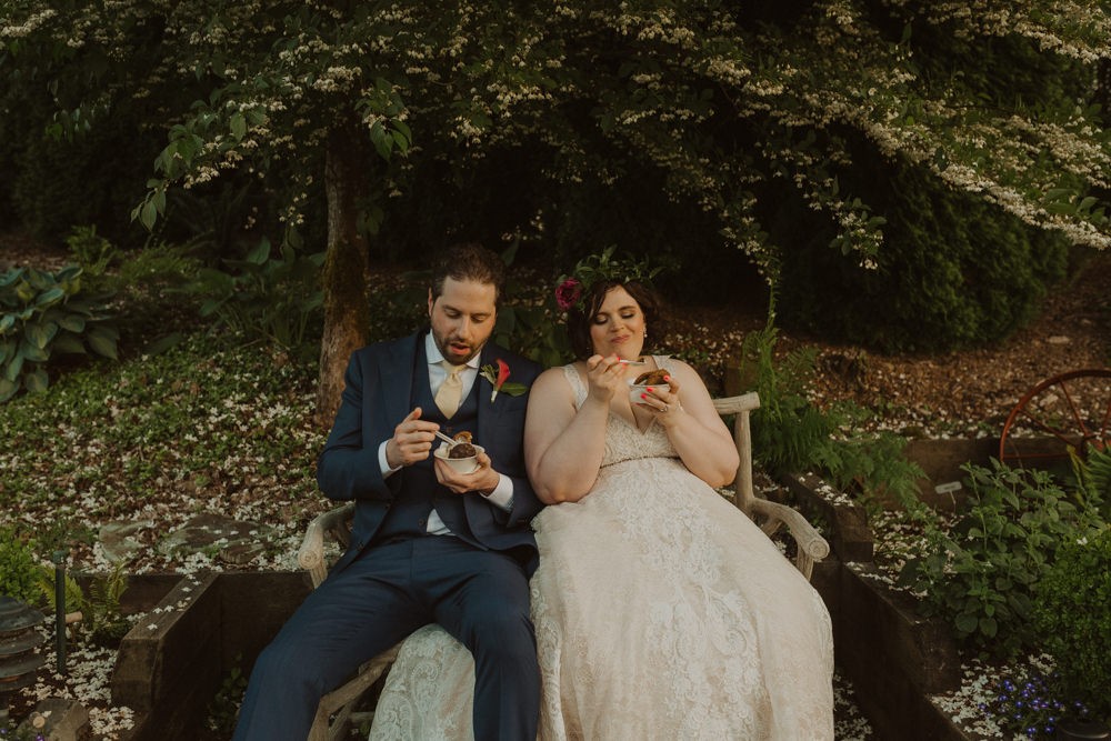 Bride and groom relax with ice cream cookie sandwiches during wedding reception at Willows Lodge. 