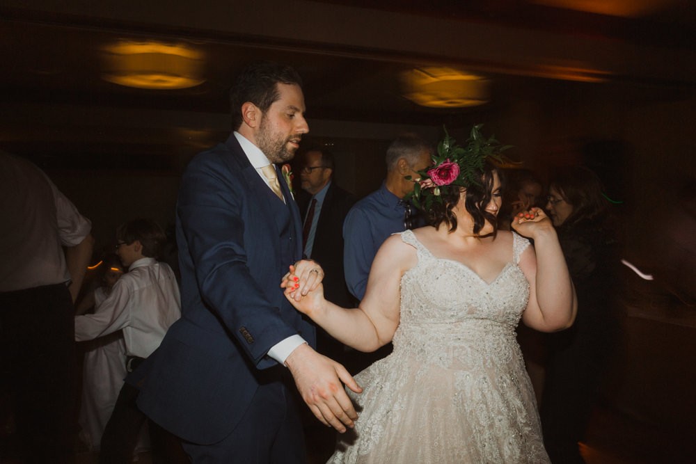 Bride and groom having a blast dancing at wedding reception. 