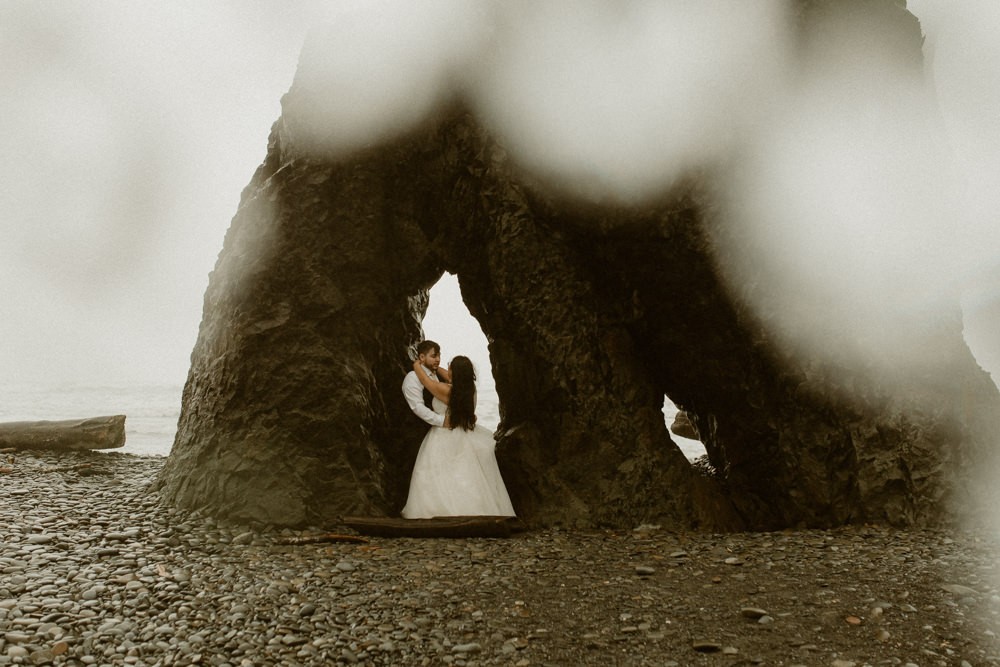 Ruby Beach elopement with wedding couple standing near a sea stack. 
