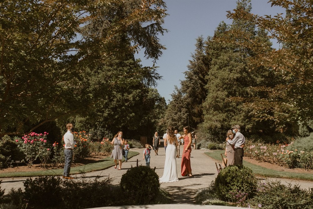 Socially-distanced wedding gathering at Woodland Park Rose Garden. 