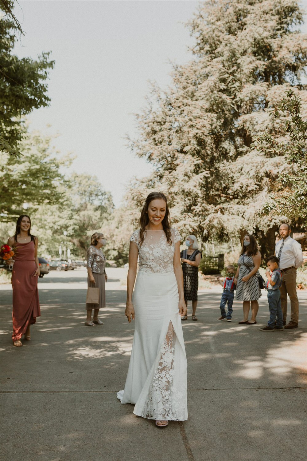Seattle bride wearing a modern illusion neckline wedding dress with floral appliqué and high slit. 