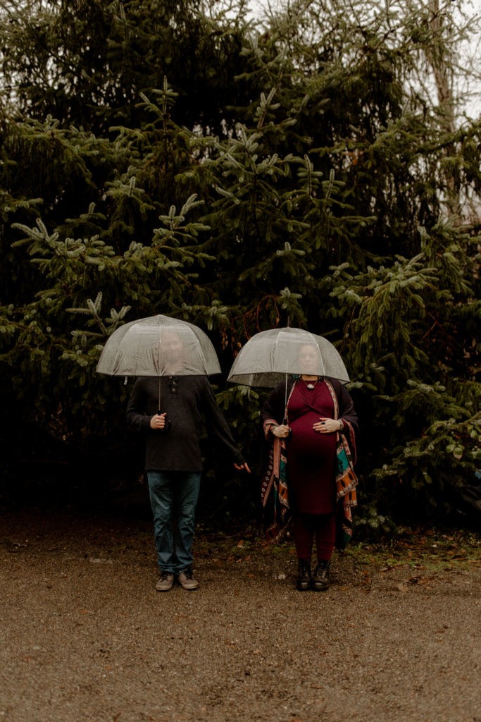 Moody and stormy maternity photos in Kitsap County Washington with clear bubble umbrellas. 
