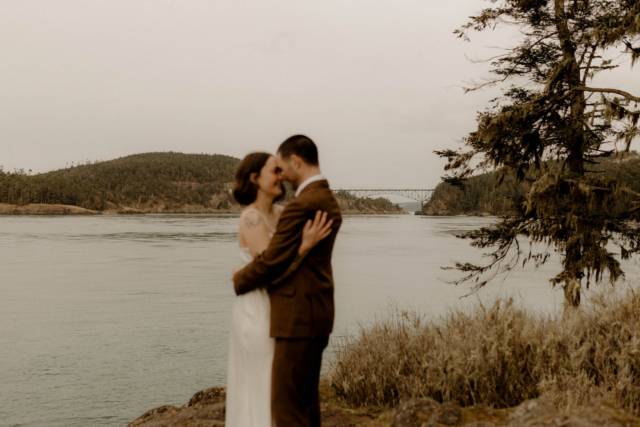 Lowkey PNW elopement on Whidbey Island with Deception Pass Bridge in the distance. 