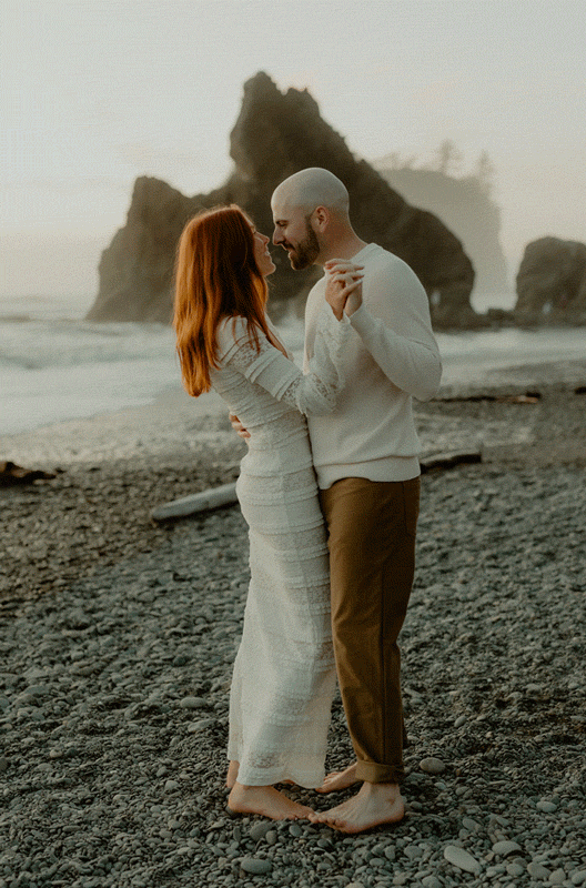 Couple dancing on the beach at dusk with ocean waves and sea stacks