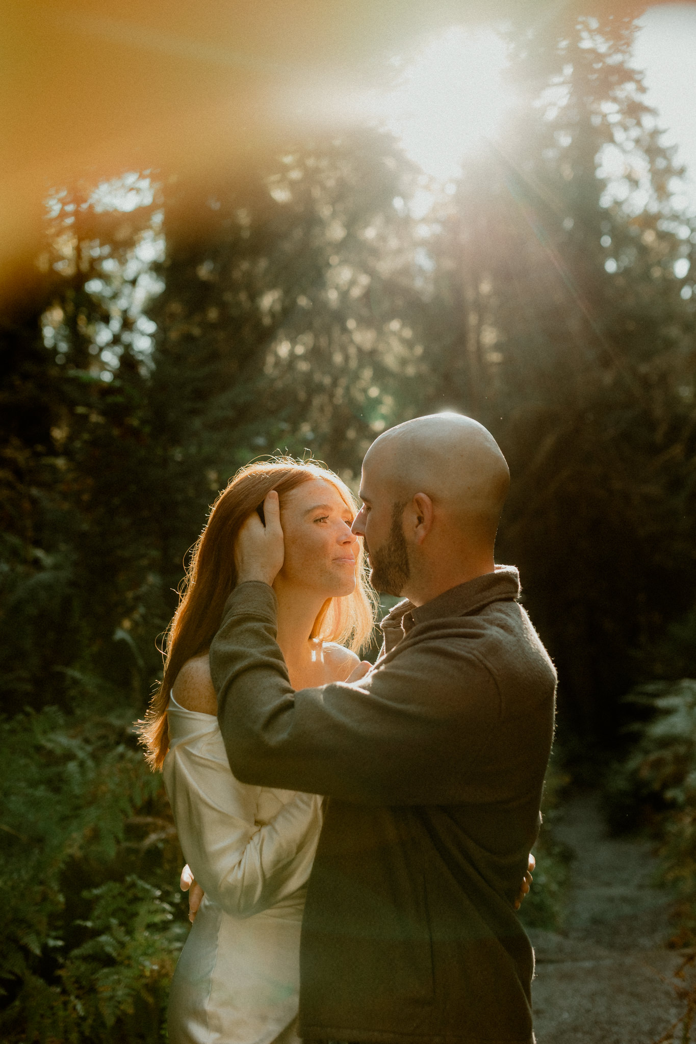 Engaged couple exploring mossy forest in Hoh Rainforest Olympic National Park