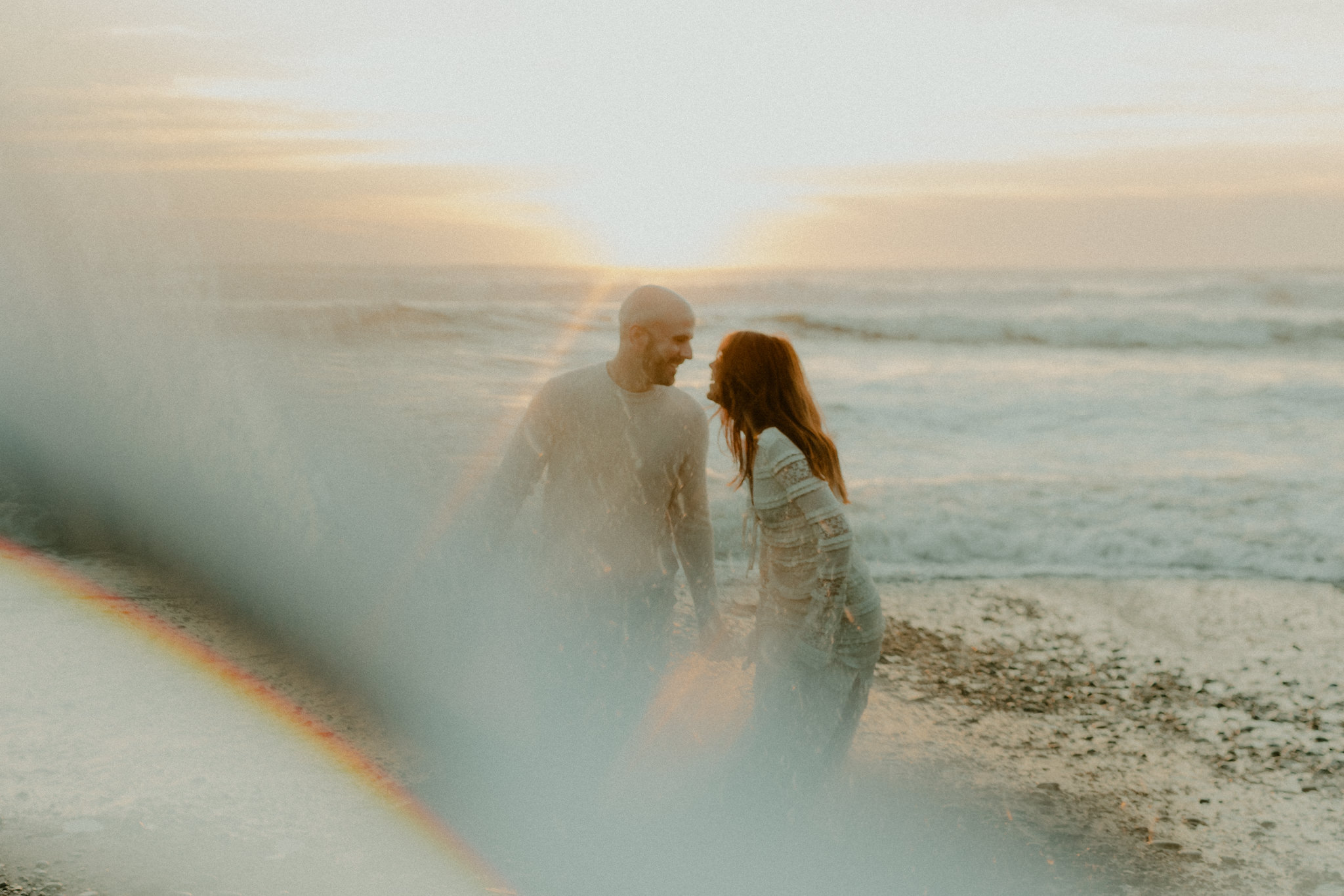 Couple playing in the waves at Ruby Beach in Forks, Washington